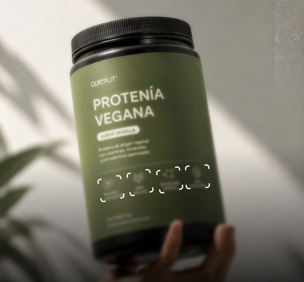 A tub of vegan protein held in one hand, the seal’s brackets printed on the label.